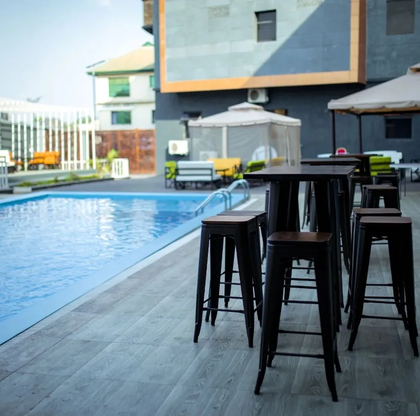 Cifaro poolside area with blue water and shaded seating